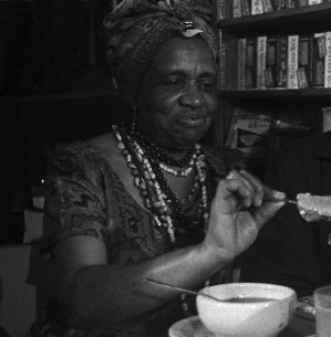 09 Jan 1968, Chicago, Illinois, USA --- Original caption: Negro comedian Dick Gregory ate his first meal of solid food in a Chicago health food store, since ending his 40-day fast in protest of the war in Viet Nam. Alvenia Fulton (L) who guided and directed Gregory's fast, tells him that the mock chicken leg he is about to eat is made of ground soy beans. Gregory who had not taken any nourishment other than distilled water between Thanksgiving Day and New Year's Day, has been on a liquid diet in preparation for the ingestion of solid food. --- Image by © Bettmann/CORBIS